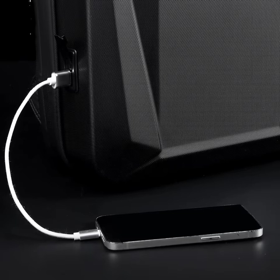 USB pass-through port on the side of the bag connected to a phone